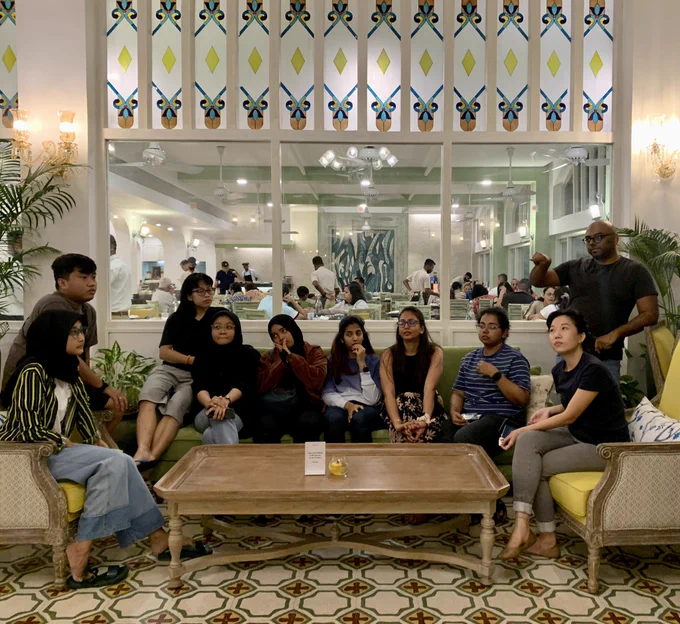 Jiva’s design team sitting in a hotel lobby listening to @isnav explain the game of Murder