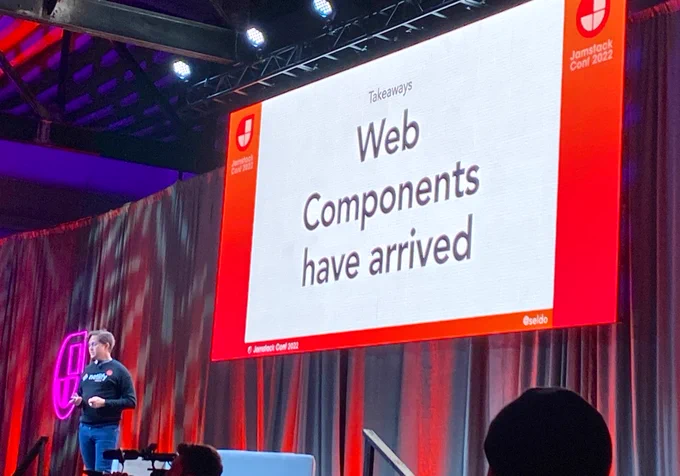 Conference slide on a stage reads: “web components have arrived”