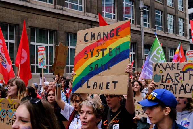 Protest where the main sign says Change the system to save the planet