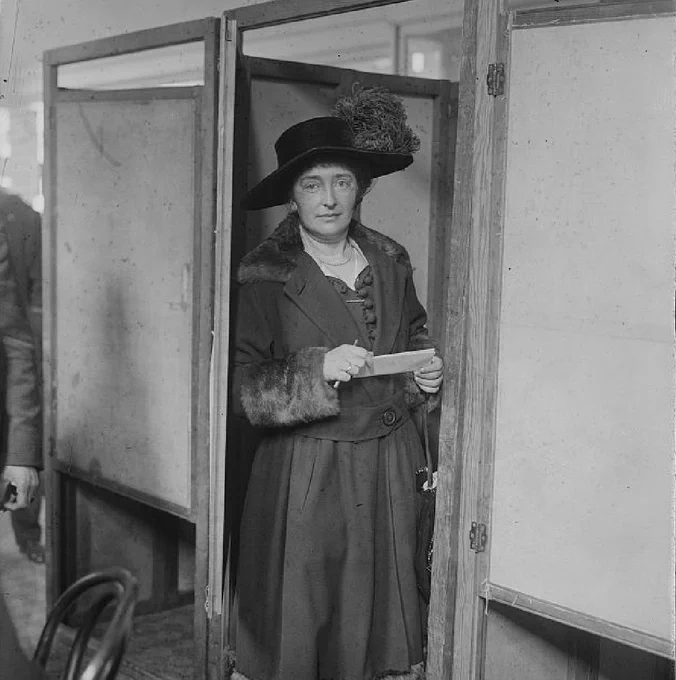 Margaret V. Lally at the door of a voting booth during the first election where women could vote. New York City, 1918.  Image: Bain News Service photograph collection, Library of Congress Prints and Photographs Division. 