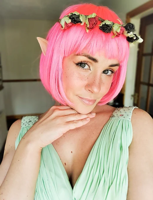 photo of turtletickles in an elf/fairy cosplay with bright pink hair 
