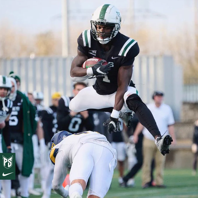 Emmanuel Daigbe hurdles a defender.