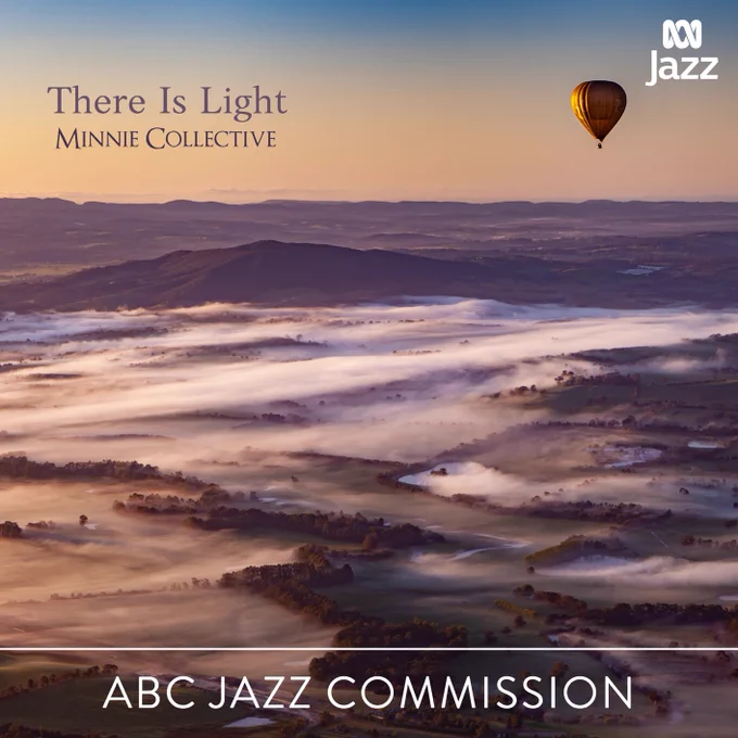 A picture of balloon floating above a foggy valley at dawn