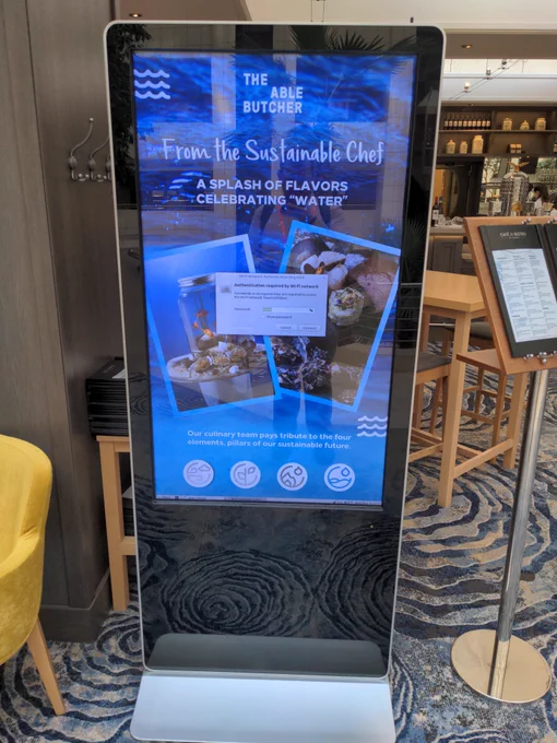 A WiFi authorization popup on an electronic menu display.