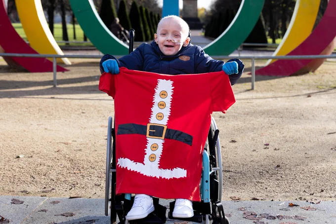 Brave Cole Park shows off the new Santa Dash T-shirts ahead of the family fun run.