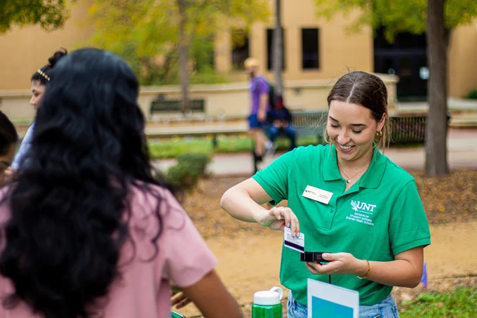 staff checks in student with ID reader