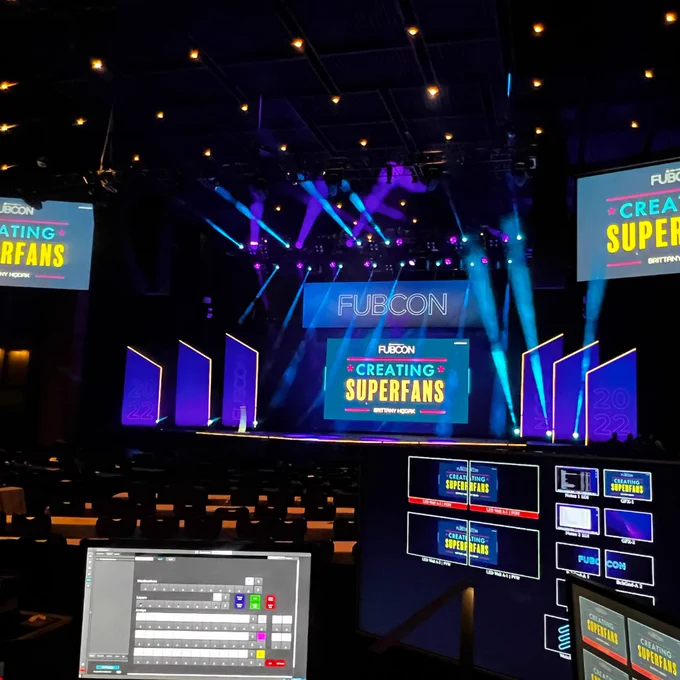 Picture of Brittany's Creating Superfans Keynote during sound check with colorful lights