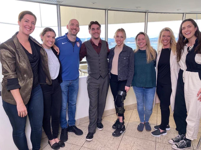 a photo of several adults standing together in a hotel for a photo with RJ Mitte, an actor from Breaking Bad who has cerebral palsy.