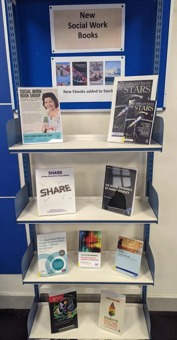 Social Work books on display on shelves in the library. 