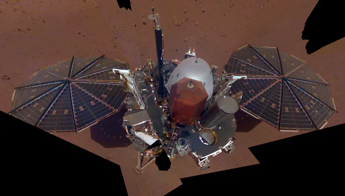 Self-portrait photo from NASA’s InSight lander shows a wide-angle composite of images capturing the vehicle on the surface of Mars during the 10th day of its surface mission. In the middle is the deck of the lander, with various science instruments on board. Extending to either side are the lander’s two solar panels.