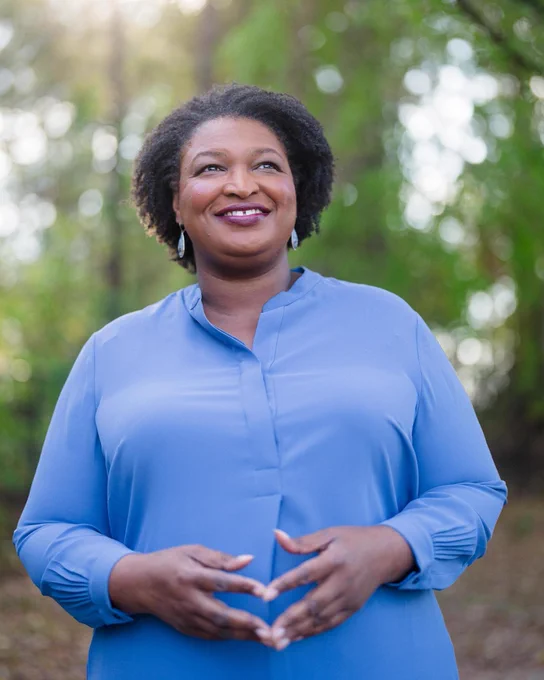 Stacey Abrams, standing on Election Day, 2022, outside in Blue, looking forward to the future. Photo taken by Kevin Lowery