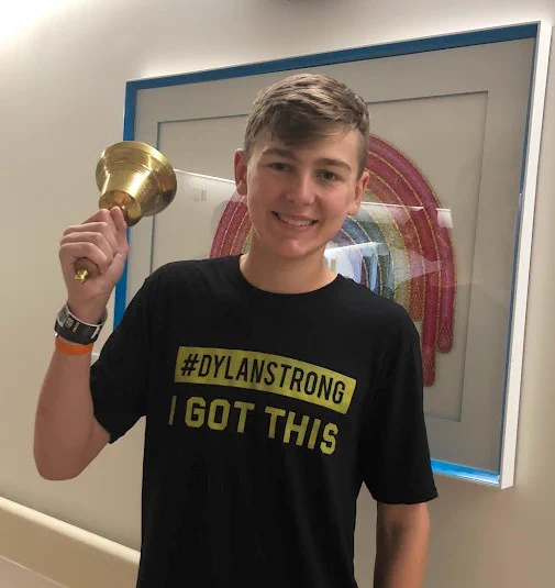 Dylan Waduck ringing the bell at Sick Kids Hospital.
