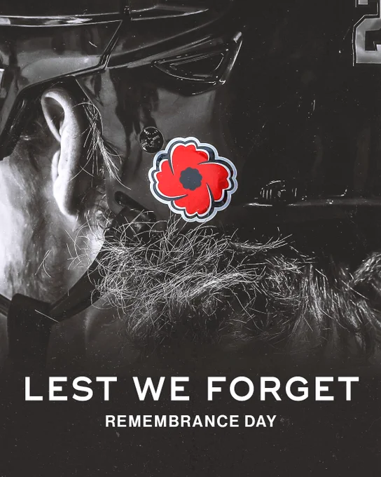 Photo of a player's helmet with a poppy on the back of it. White text at the bottom of the photo reads, "Lest we forget. Remembrance Day"
