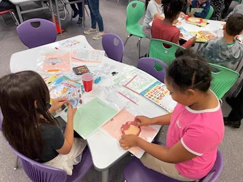 Students decorating book bags and bookmarks 