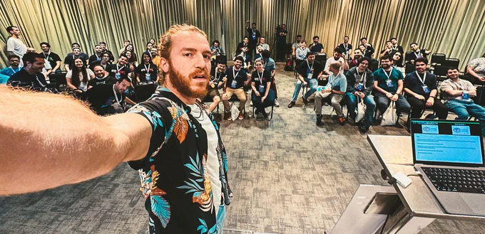 Selfie of me with on the conference stage with the audience in the background.