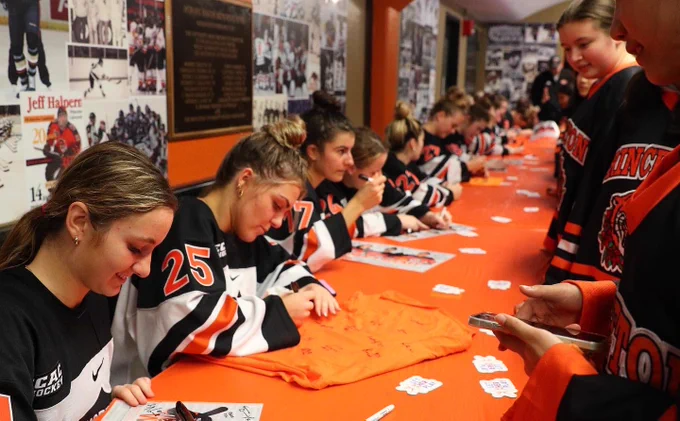 Players signing autographs
