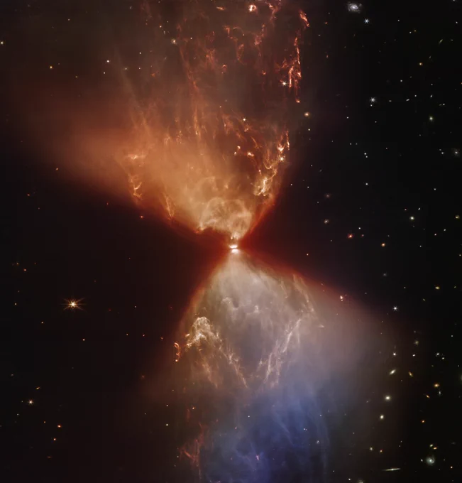 Cones of light at the top and bottom contrast against cones of shadow to the left and right. The brightest part near the center is crossed by a dark line. The image is redder at the top where the dust is thicker, and bluer at the bottom where there is less dust. Various galaxies and foreground stars are visible throughout the image, but less so on the left upper and central side where the dust obscures them. Intricate textures from dust shaped by outflows from the star are visible throughout the light cones.

Now there's also less horizontal banding!
