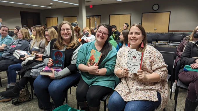 Three readers pose with their books
