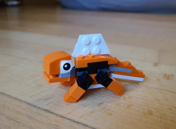 Photo of a small LEGO dinosaur model with a sail on the back