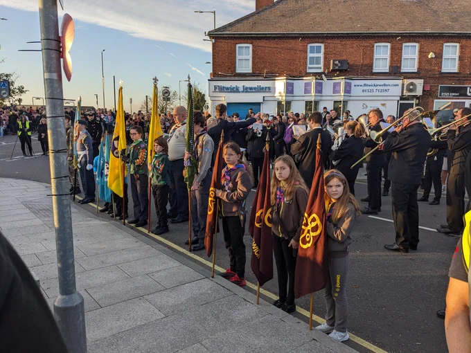 Two Beavers with a blue flag each, two Cubs with a Yellow flag each, an Explorer Scout with a green flag, and 3 Brownies with a brown flag each