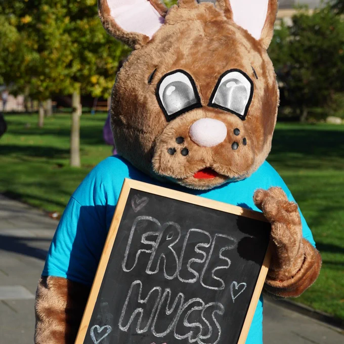 Kent Bunny holding a sign that reads 'Freed hugs #WorldKindnessDay'