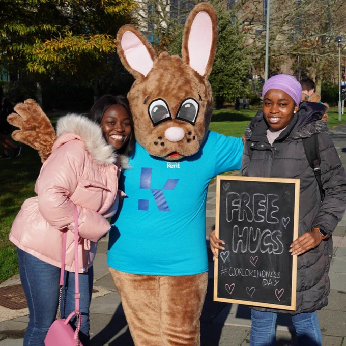 Two students smiling for a photo with Kent Bunny 
