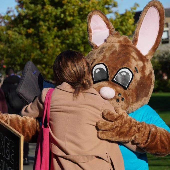 Student hugging Kent Bunny 