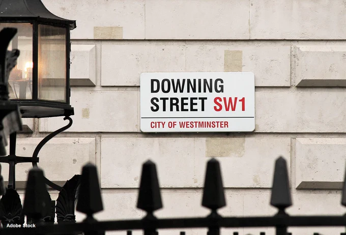 View of the gates to Downing Street and the road name plate.