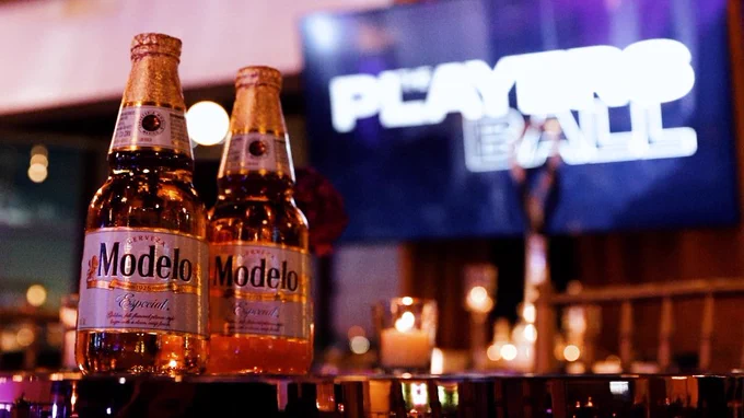 Modelo shot in front of The Players Ball branded monitor