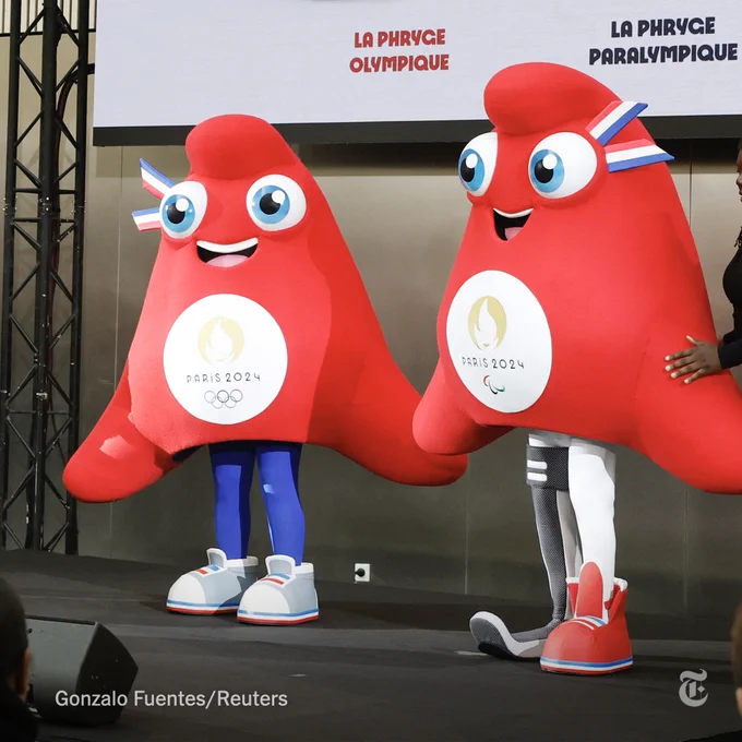 The Paris 2024 Olympics and Paralympics mascots, the Phryges, are red, soft hats. They're wearing sneakers and have blue eyes with red, white and blue ribbons on them. Photo by Gonzalo Fuentes/Reuters.