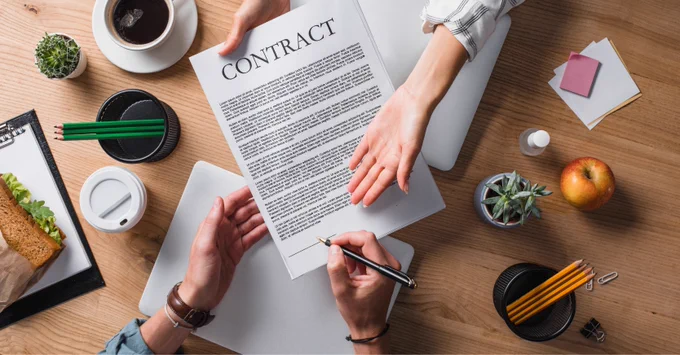 A person signs a contract.