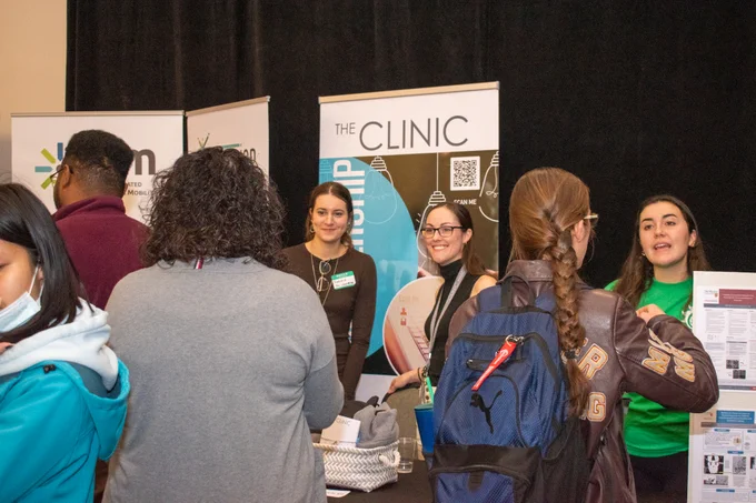 Group of students learning about services at booths.