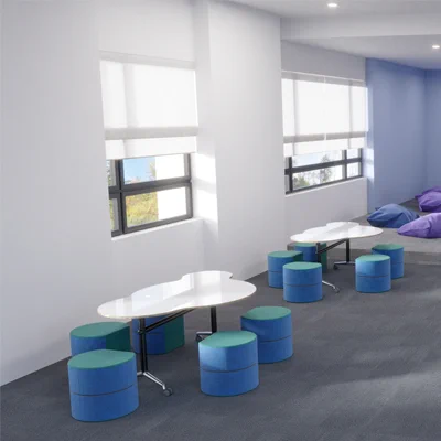 A corridor space furnished by Beparta showing 2 cloud-shaped foldable tables with 5 Rockable seats in blues and teals. Some foam-filled large cushions can be seen in the background