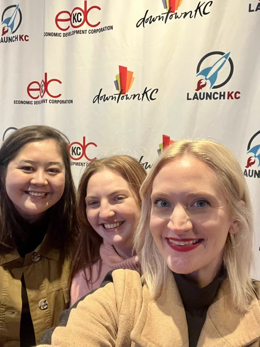 Women posing in front of LaunchKC sign