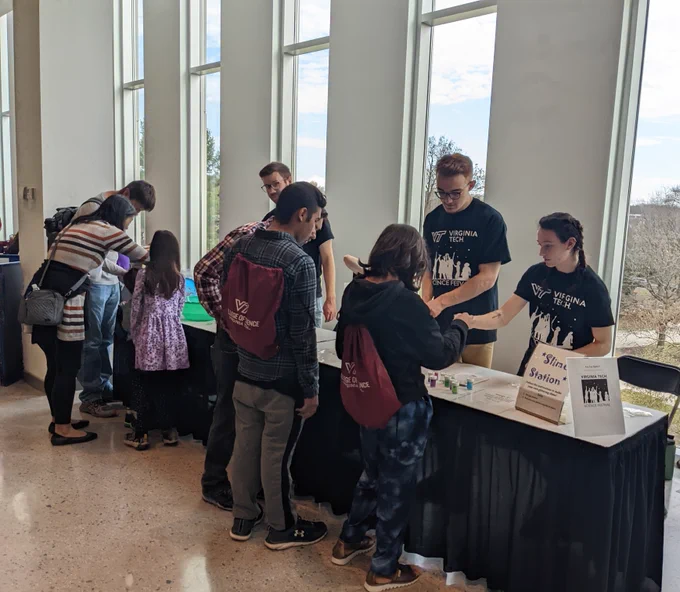 Group members helping visitors make slime during the event