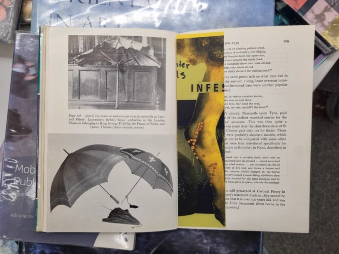 A yellow bookmark in a book about historical umbrellas