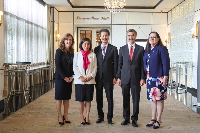 Ambassador Tai, second from left, in a white blazer and pink scarf, stands with leaders of the National Center for APEC. 