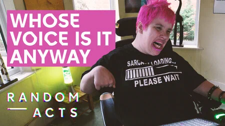 A 40-year-old person with Athetoid Cerebral Palsy in an electric wheelchair with an Augmentative Communication Device (AAC), smiling excitedly in a room with a bay window.  She has pink hair and is in a black t-shirt that reads, "SARCASM LOADING... PLEASE WAIT". In the top left hand corner of the image, the title 'Whose Voice is it Anyway' is written in capital letters in white on a pink background. At the bottom left hand corner of the image is text that reads 'Random Acts' in white.