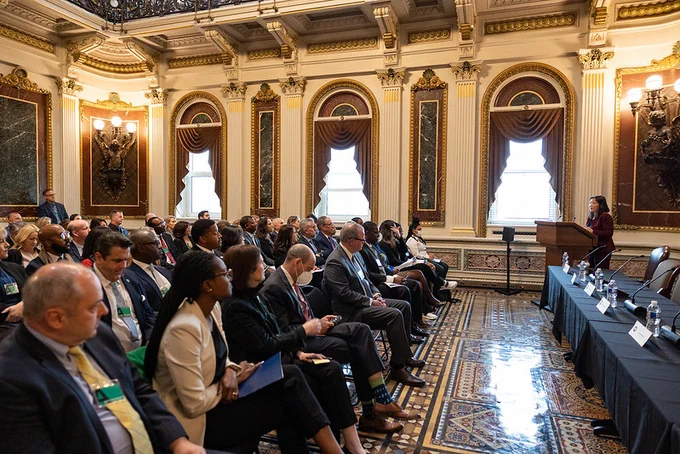 Labor Deputy Secretary Julie Su speaks at a podium in the White House, in front of a crowd of people. 