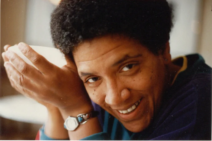 close up image of Audre Lorde smiling and looking towards the camera. 
