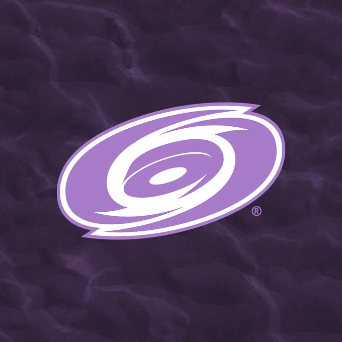 A lavender Canes logo on a dark purple background, as tonight's game marks the team's annual Hockey Fights Cancer game
