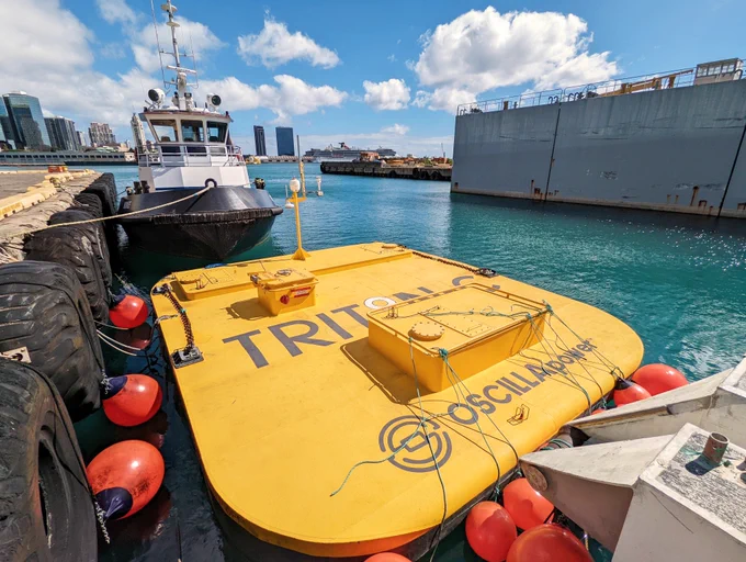 A wave energy device sitting on harbor dock