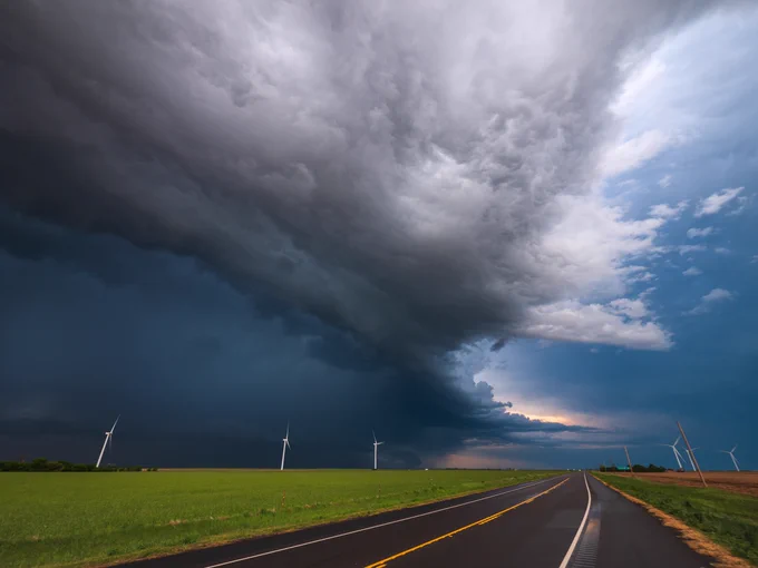 Grey storm clouds hover over green crops.