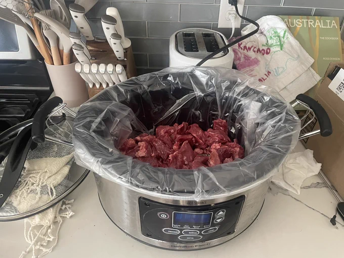 2lbs of beef sitting in the bottom of the slow cooker