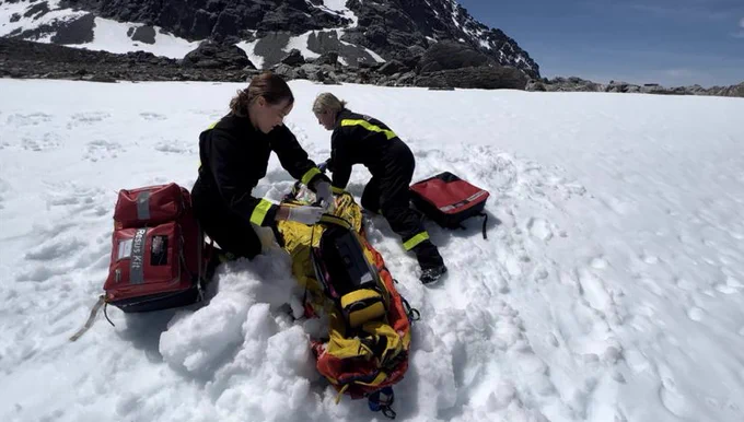 Avalanche rescue simulation in action: Paramedics taking the hypothermic patient (medical manikin) onto the helicopter.  