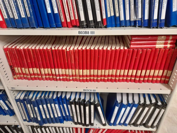 A book shelf containing volumes of Braille books. The centred shelf contains 45 volumes of the book "Les Misérables".
