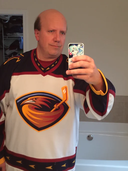 Selfie of @invalidname from 2016, wearing an Atlanta Thrashers jersey, photographed with an iPhone in a Hatsune Miku case.