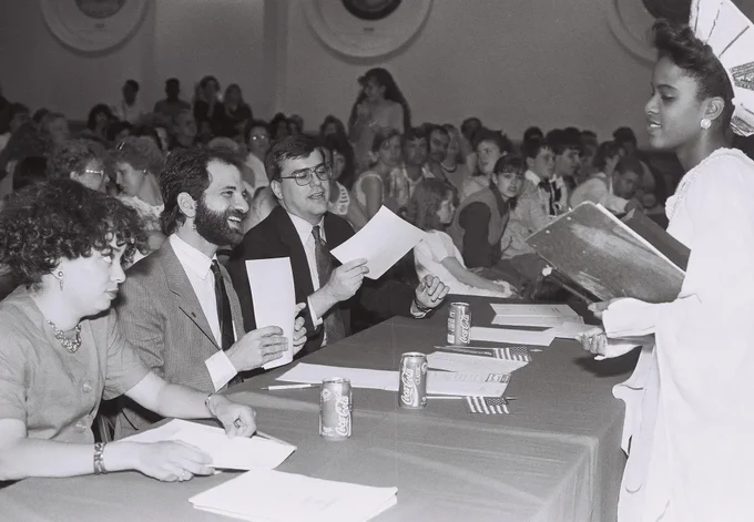This photo is an NHD performance student handing judges project paperwork. 