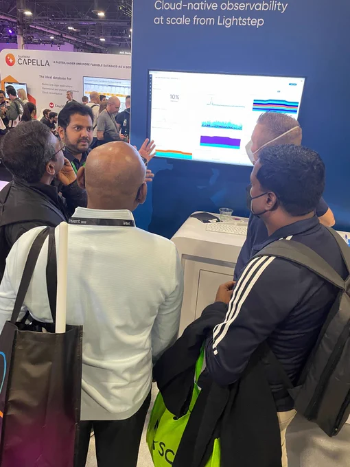 AWSre:Invent 2022 attendees swarming the Lightstep booth and watching a demo.