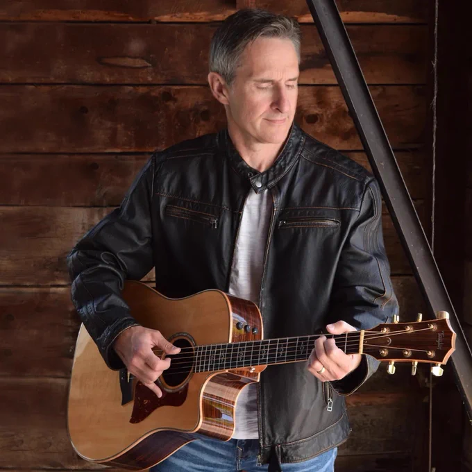 Musician Dave Carroll plays guitar.